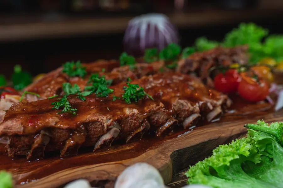 Zarte Spare Ribs mit BBQ-Sauce und Petersilie auf Holzbrett